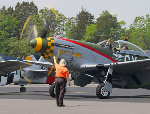 Marshaller giving thumbs up to Mustang pilot