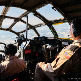 Visitor climbing into the cockpit of a historic aircraft at Aviation Discovery Fest